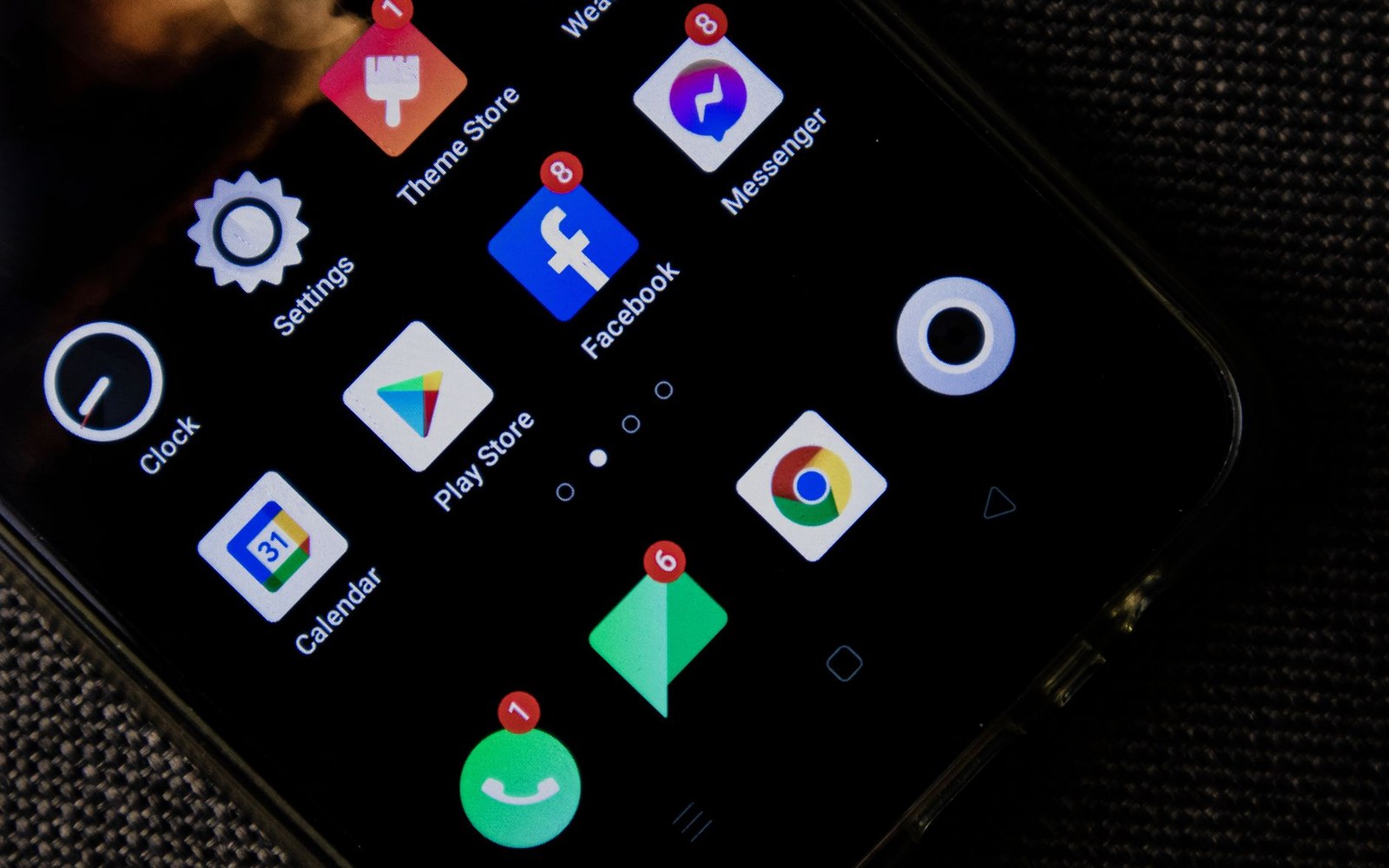 Smartphone home screen showing app icons with unread notification badges on Facebook and Messenger
